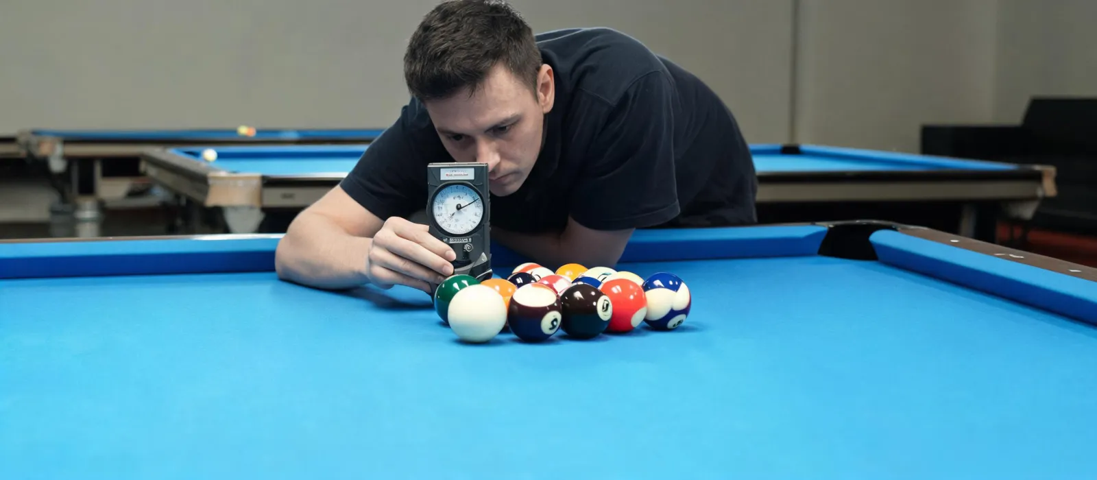 Billiard room technician checking a matched ball set